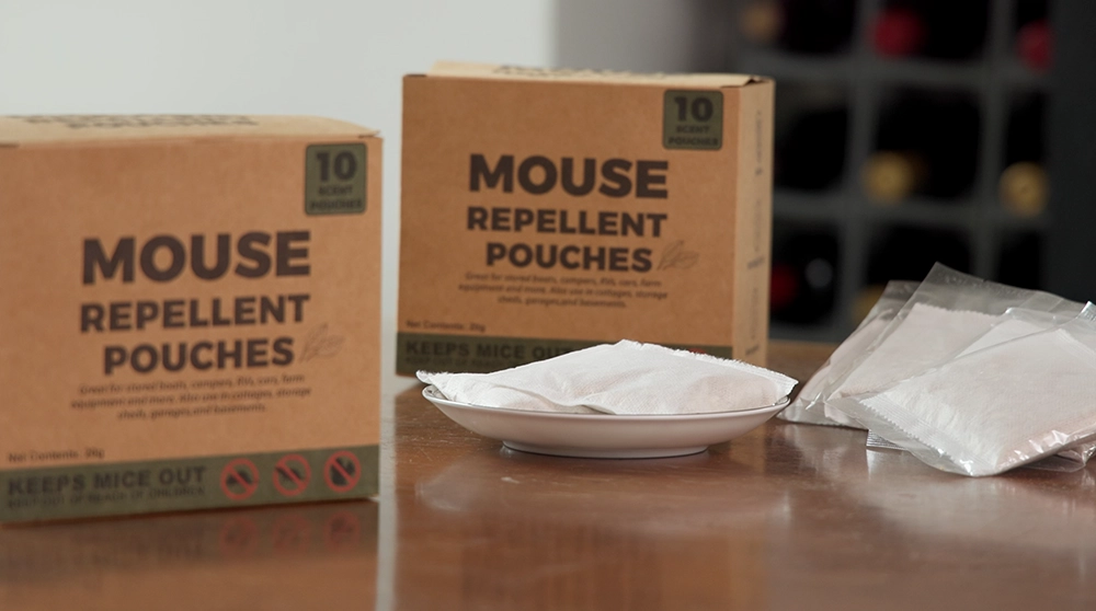 Two boxes of PestVault mouse repellent pouches with scent pouches on a table